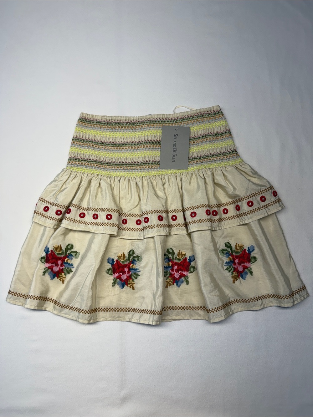 See And Be Seen Smocked Cream Mini Skirt with Embroidered Floral Motifs